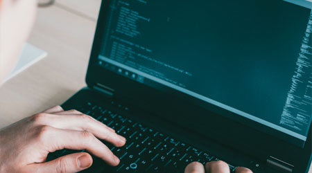 Software engineering developer writing code laptop