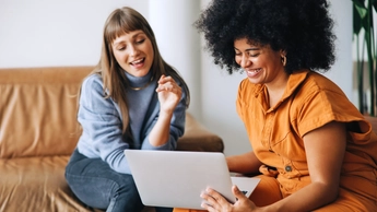 two women looking at laptop