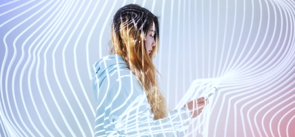 Woman using mobile phone in the holographic background 