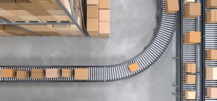 Top view of conveyor belts transporting boxes in a large warehouse