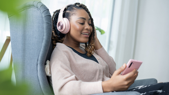 woman listening to mobile device with headphones