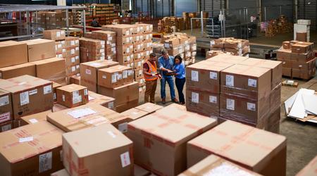 Shot of people at work in a large warehouse full of boxes