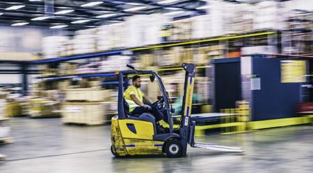 Blurred motion of forklift in warehouse