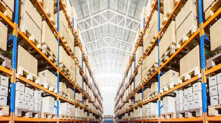 Rows of shelves with boxes in modern warehouse